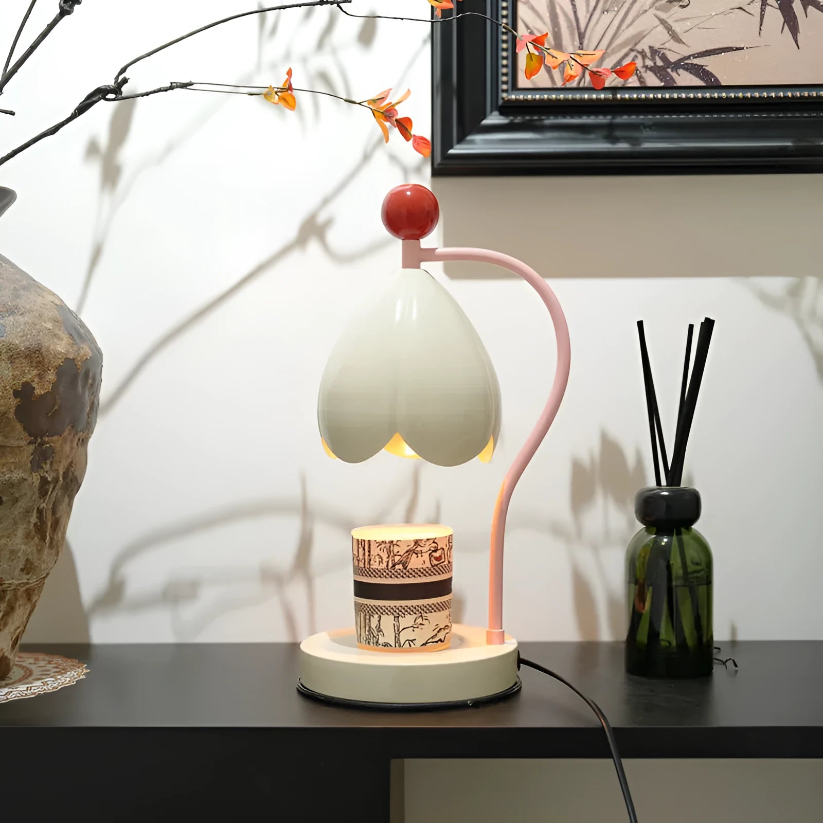 Linglan ancient style melting wax fragrance lamp on a desk, available in cream white or dark green.