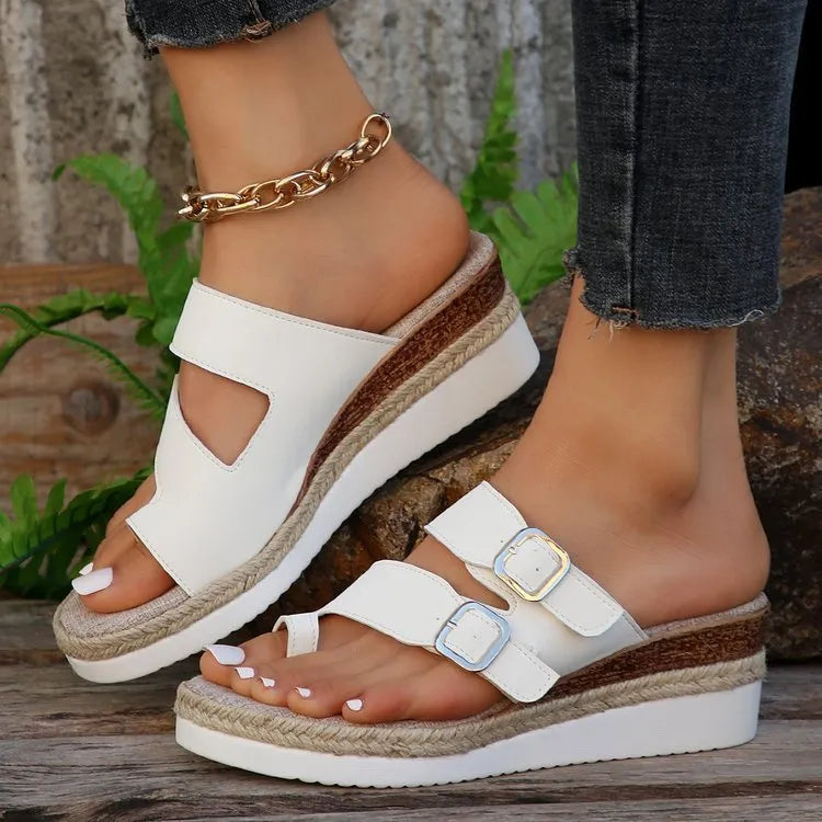 White woven patent leather peep toe wedge sandals on a rubber sole