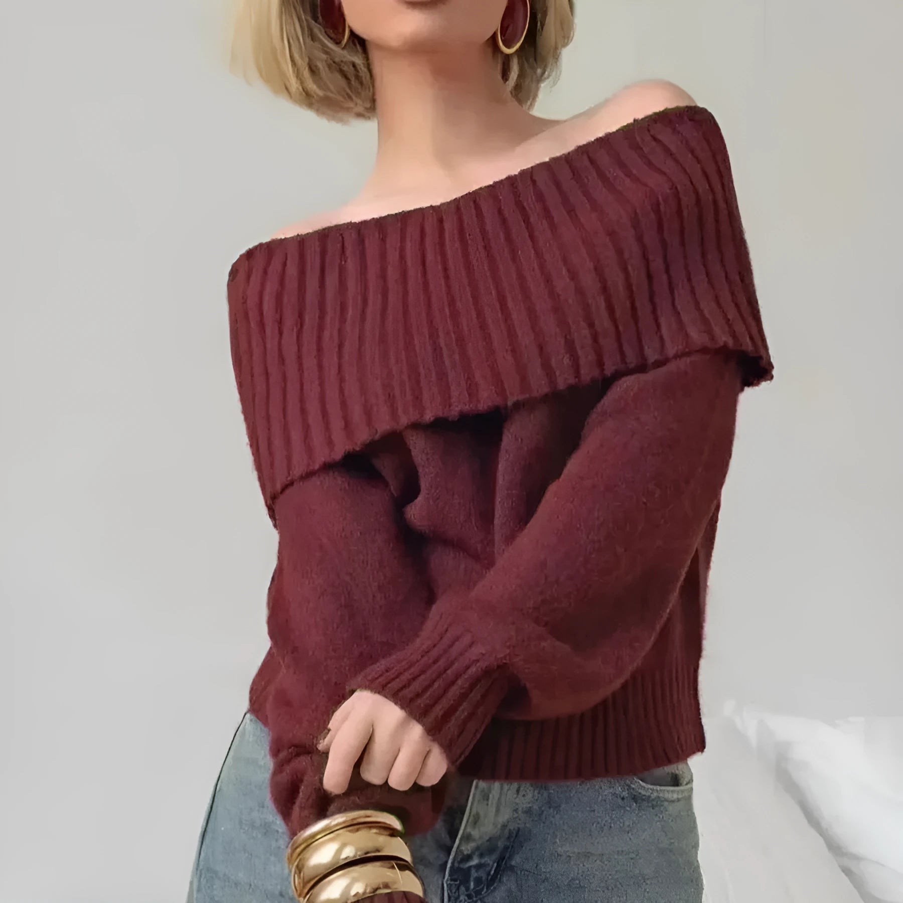 Woman wearing a grey off-the-shoulder strapless sweater with a 3D textured pattern.