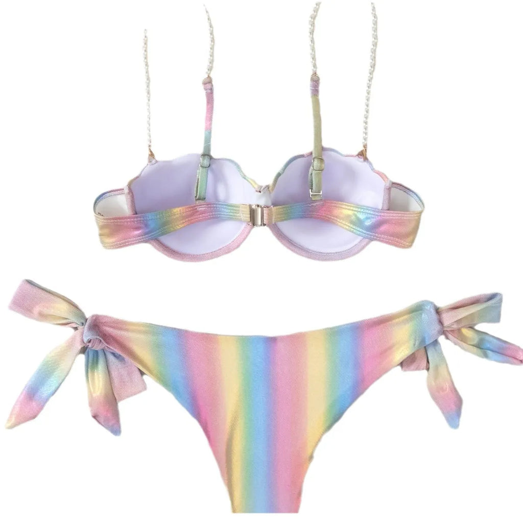 Women's shell rainbow patterned bikini swimsuit with a split tied front, on a mannequin.