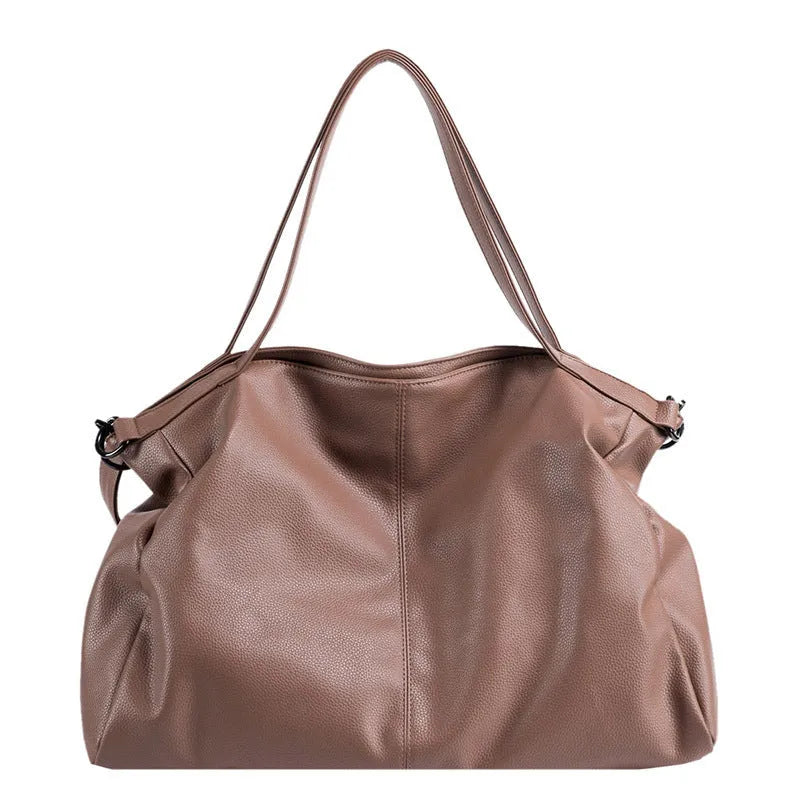 Soft surface messenger bag with adjustable strap showing mobile phone pocket and zipper compartments