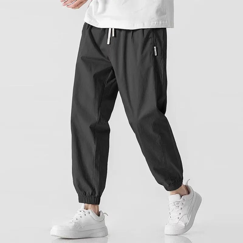 Men's fashion loose cuffed cargo pants in black, made from polyester, available in sizes S to 3XL.