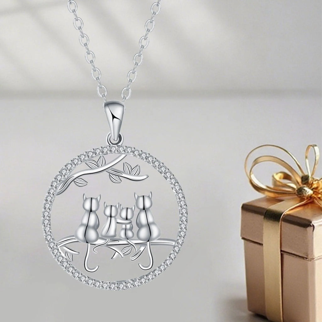 Copper necklace with four kitten pendants on a cross chain, electroplated finish.