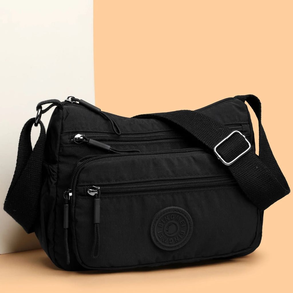 Trendy water-repellent nylon crossbody cloth bag in black with single shoulder strap and outer pocket