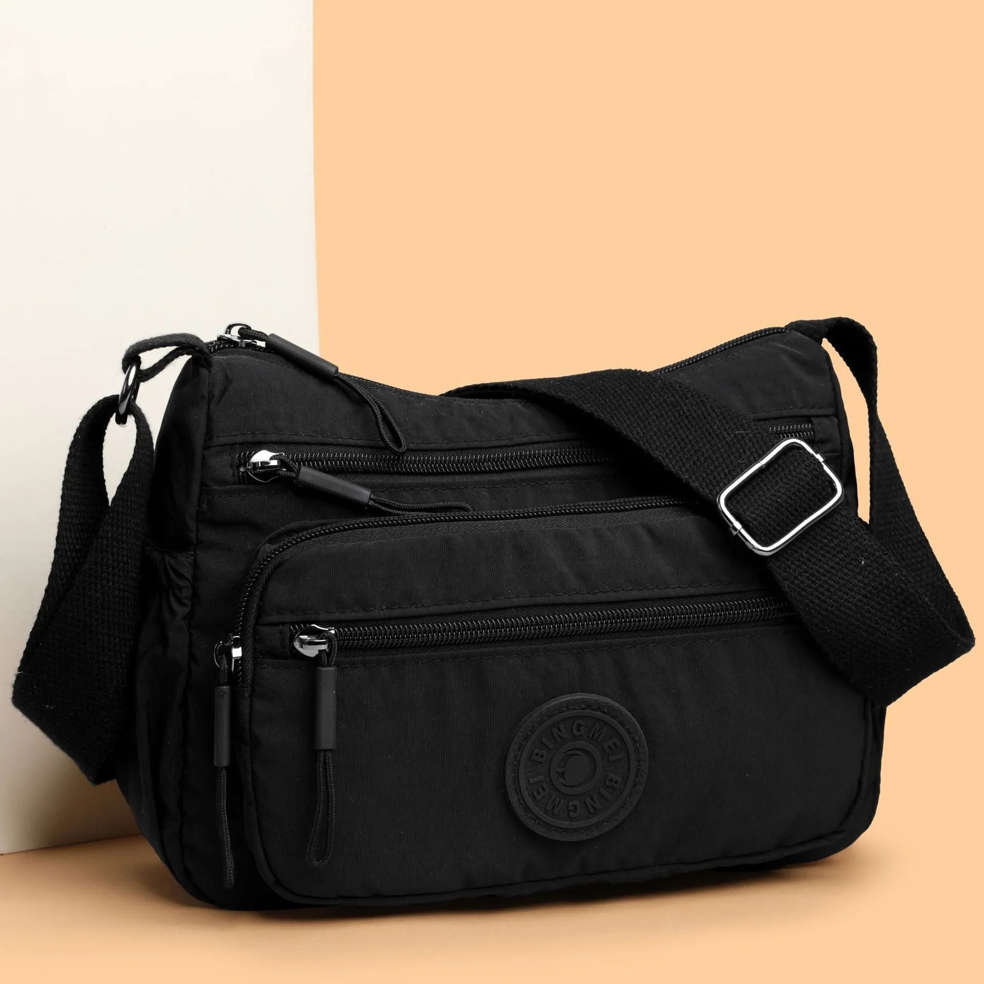Trendy water-repellent nylon crossbody cloth bag in black with single shoulder strap and outer pocket