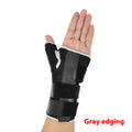 Black sports wrist guard with grey edging and a thumb strap, showing carbon fibre reinforcement panel.