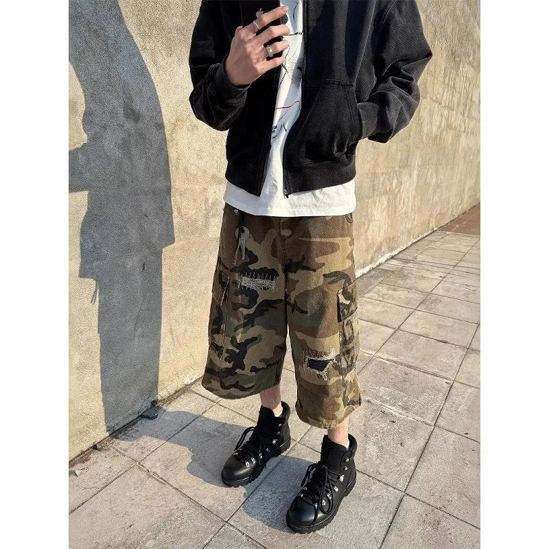 Men's camouflage cropped jeans with retro patches and ripped detailing on loose straight-leg trousers