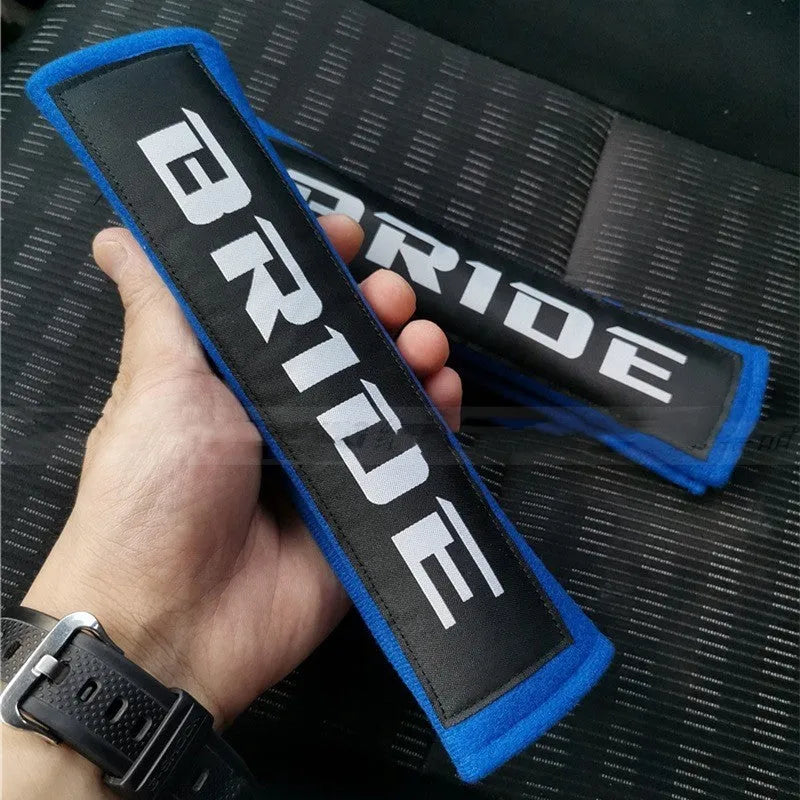 Black cotton sponge cloth car seat belt shoulder pad showing embroidery weaving texture and 22.5cm length