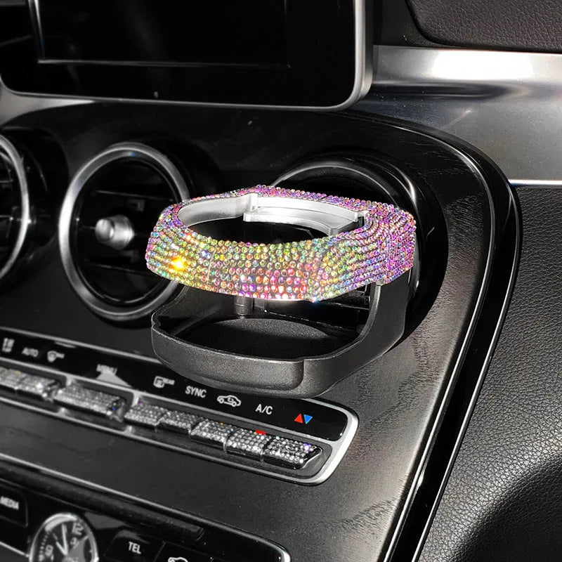 White diamond decorated ABS plastic car vent cup holder mounted in a car air vent.
