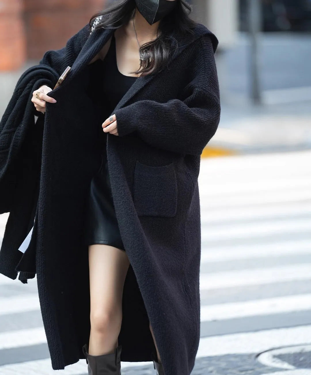 Long grey knitted hooded cardigan trench coat on a hanger showing its 80cm length and thick texture.
