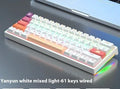 Small bluish-black 61-key mechanical keyboard with wired USB cable showing multiple switch colour options