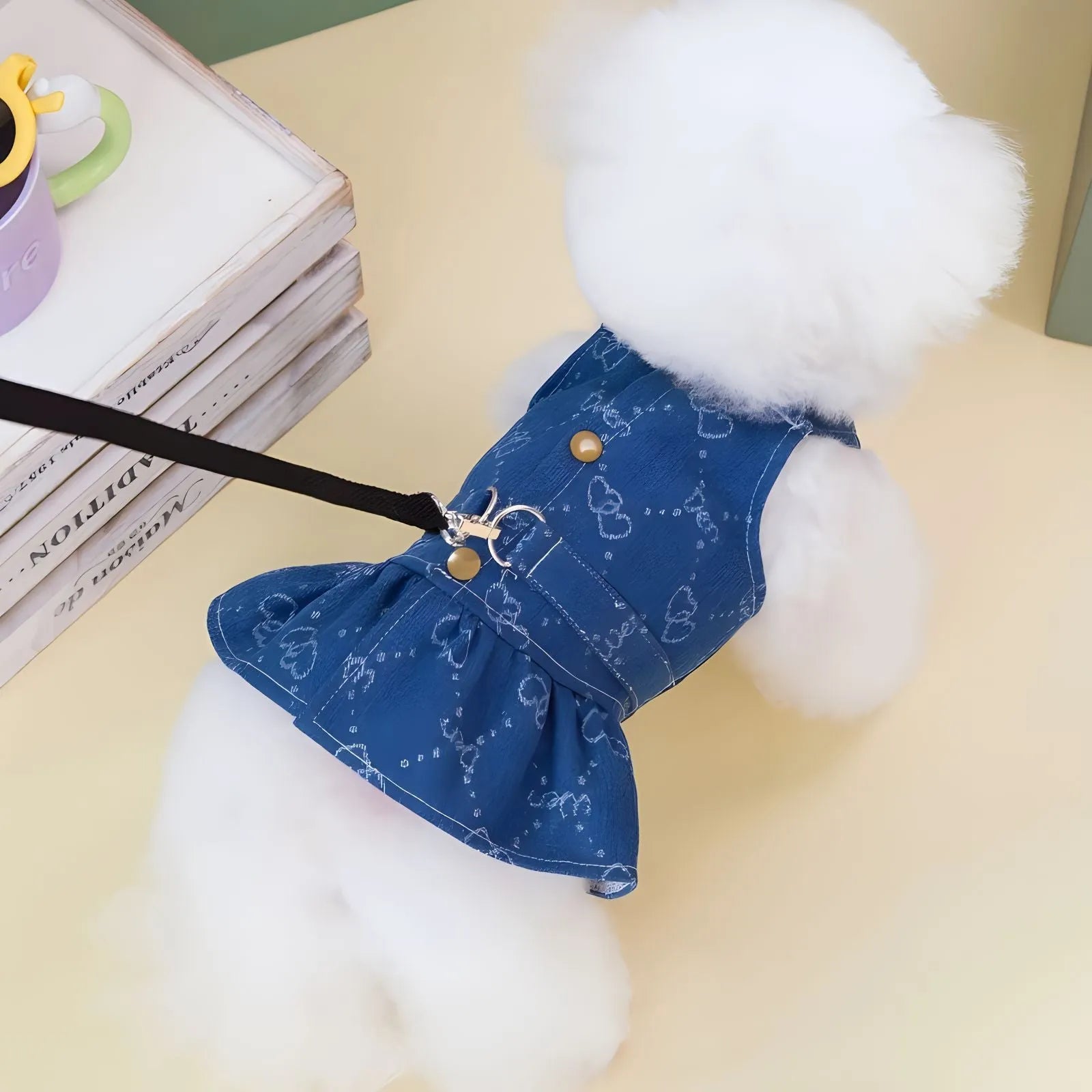 Small dog wearing denim princess dress with bracket skirt styling in blue denim fabric