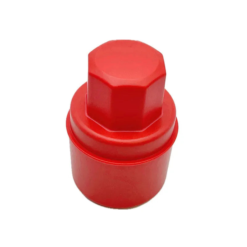 Hand-held black and red car tyre polishing sponge brushes with lids on a garage workbench.