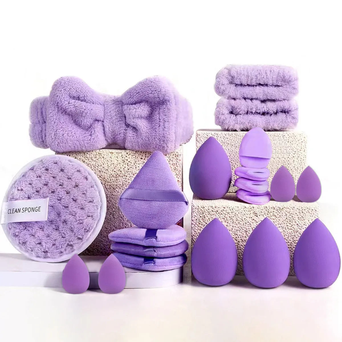 Beauty tool combination set with multiple pieces in pink, brown and purple colours for face wash and makeup application