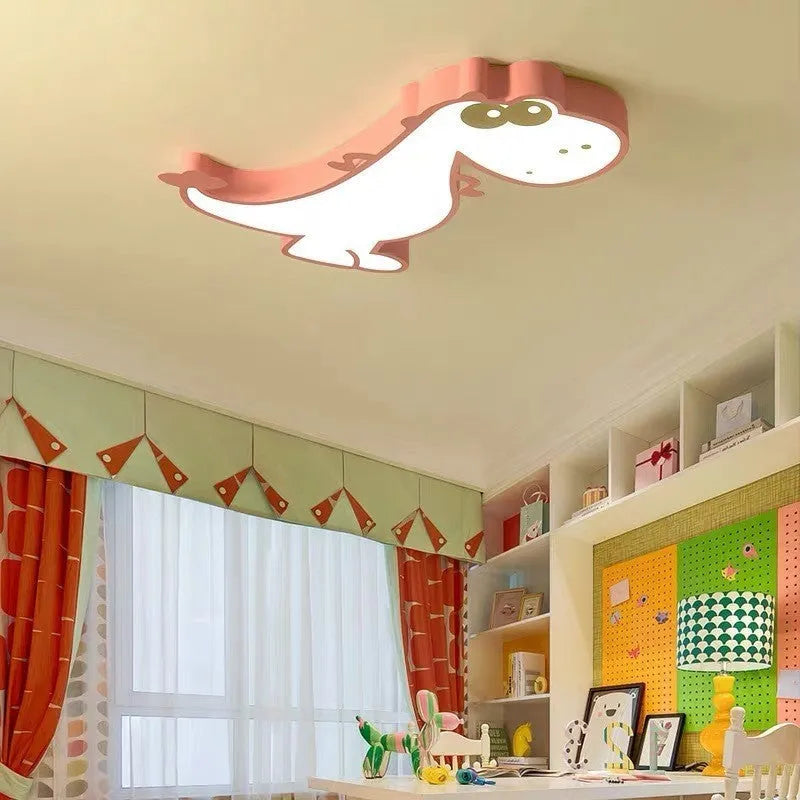 Green cartoon dinosaur ceiling light with dimmer switch on a white ceiling.