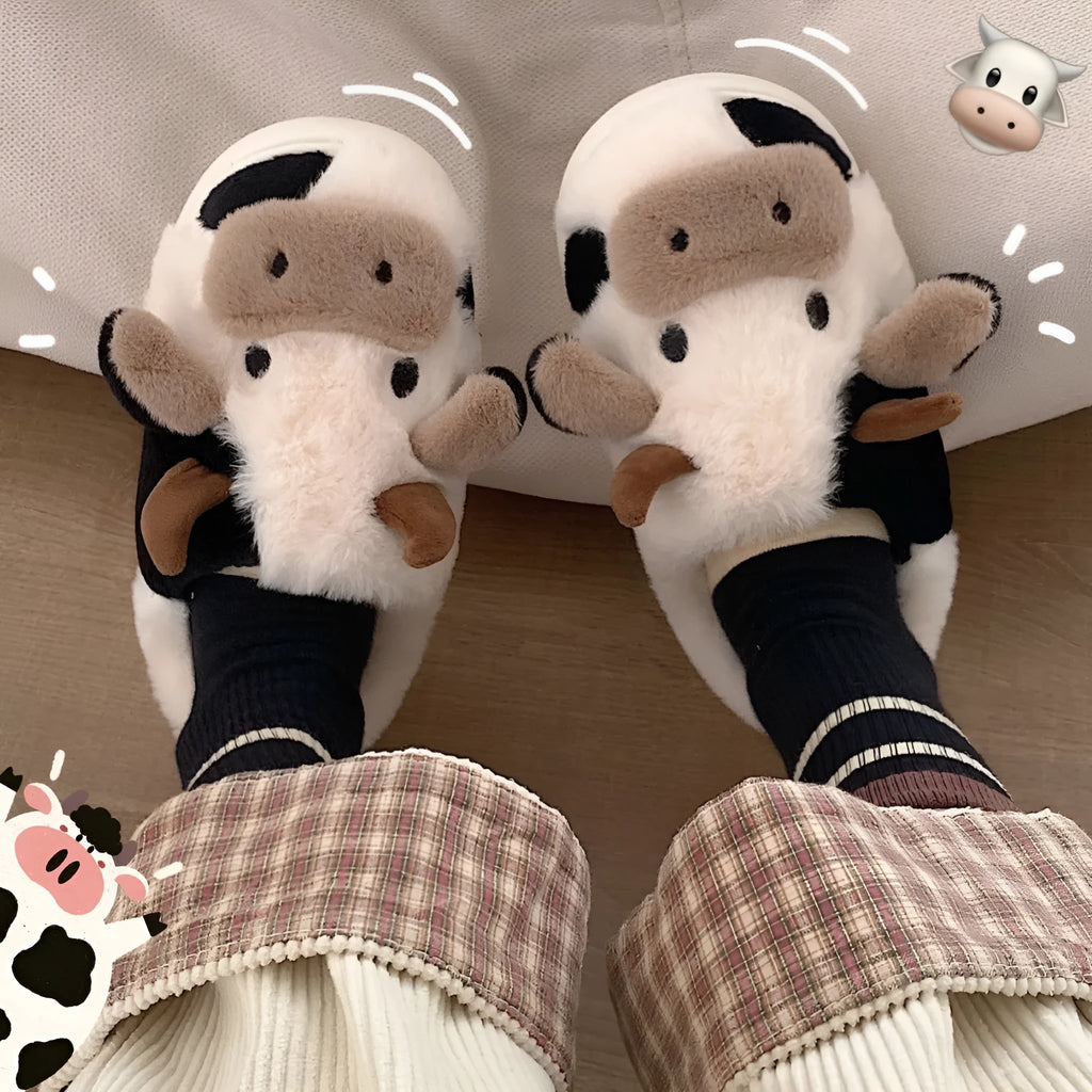 White plush cow slippers for women with a non-slip textured sole.