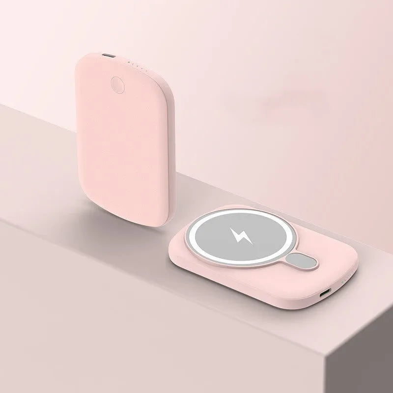 Slim Magsafe magnetic wireless power bank in Barbie Pink, shown next to an iPhone.