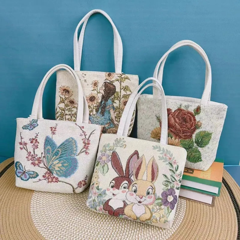 Canvas handbag with gold wire embroidery in floral and illustrative designs