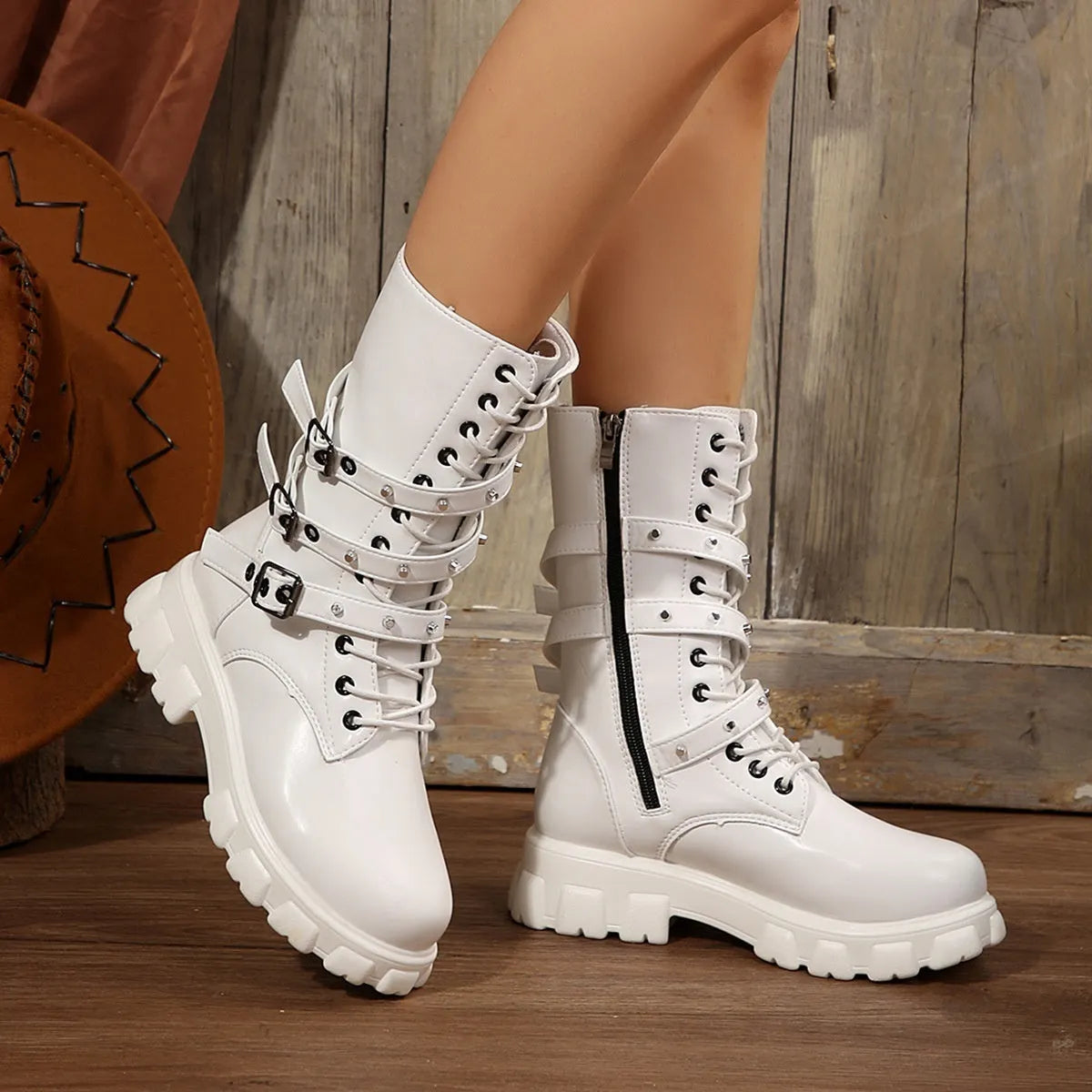 Women's black mid-calf knight boots with side zipper and metal belt buckle on artificial PU upper.