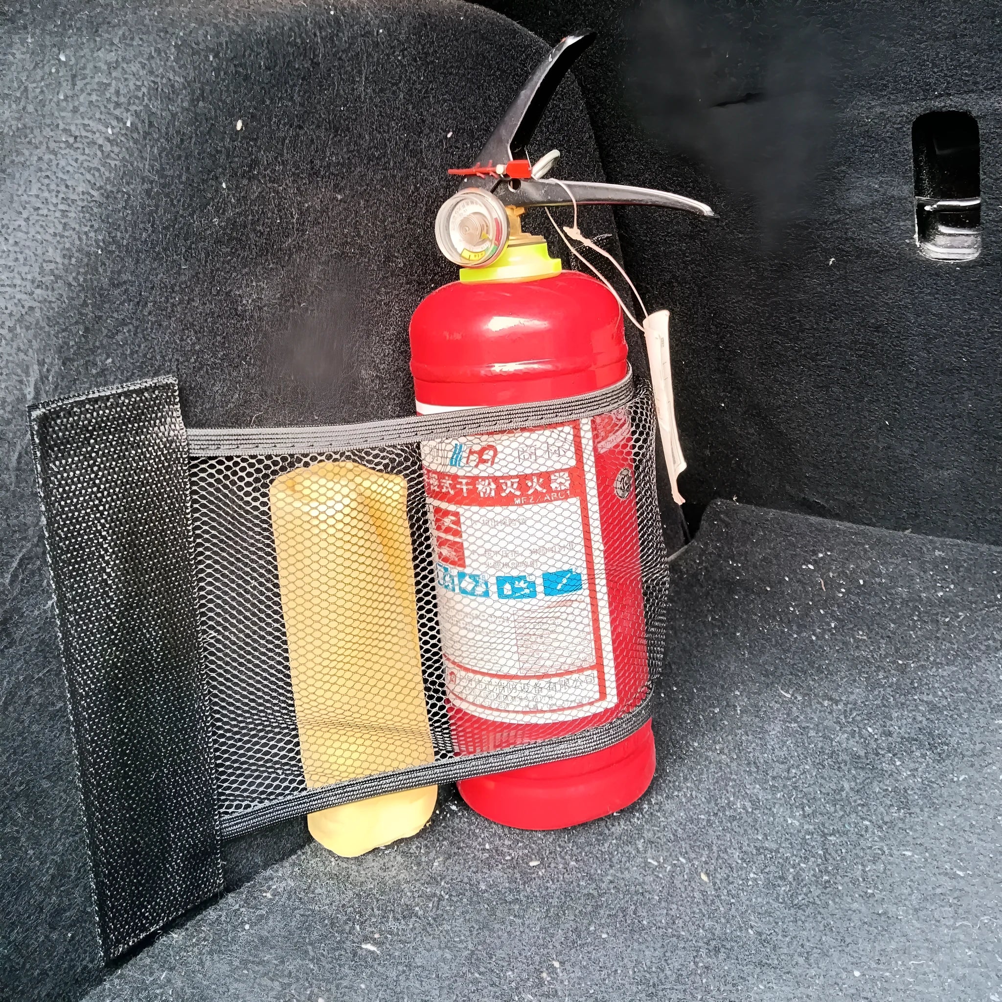 Elastic polyester car boot storage net shown in 20x45cm size securing loose items.
