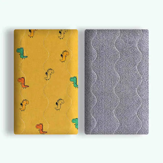 A soft cotton velvet pet blanket with a colourful dinosaur print, shown folded next to a dog bed.