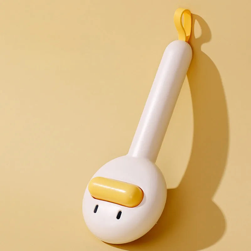 Small yellow duck-shaped pet grooming comb with needle pins for cats and small dogs