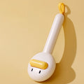 Small yellow duck-shaped pet grooming comb with needle pins for cats and small dogs