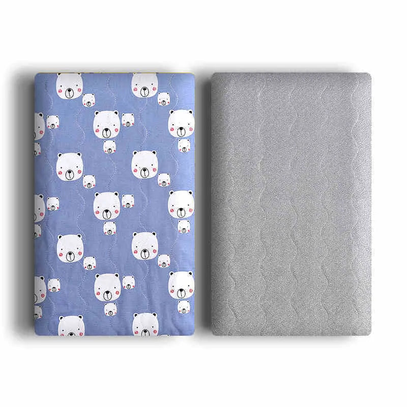 A soft cotton velvet pet blanket with a colourful dinosaur print, shown folded next to a dog bed.