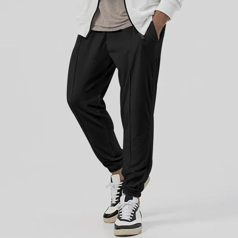 Men's grey casual track sweatpants with loose tapered cut and straight leg design, elastic waistband
