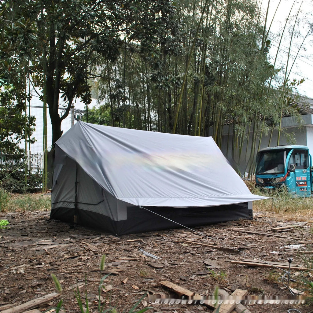 Brown or white A-line cabin tent pitched with trekking poles, showing spacious interior and waterproof fabric construction