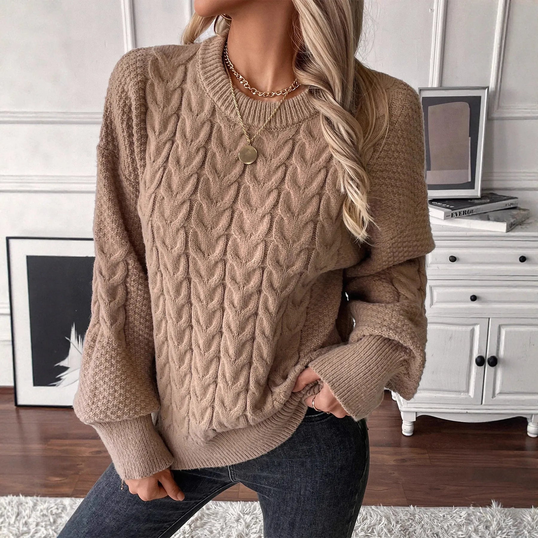 Women's beige loose round neck casual polyester sweater on a hanger.