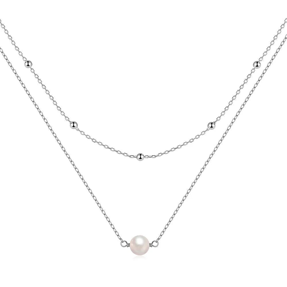 S925 sterling silver double layer necklace with twin pearls in gold or white gold finish featuring geometric pendant and ball bead chain.