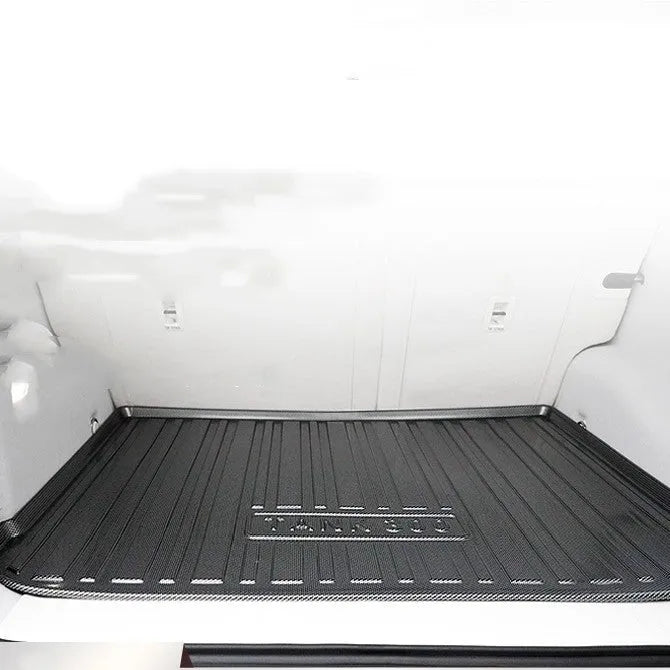 Black car trunk protection pad with a textured carbon fibre pattern, made from TPE material.