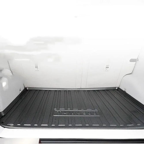 Black car trunk protection pad with a textured carbon fibre pattern, made from TPE material.