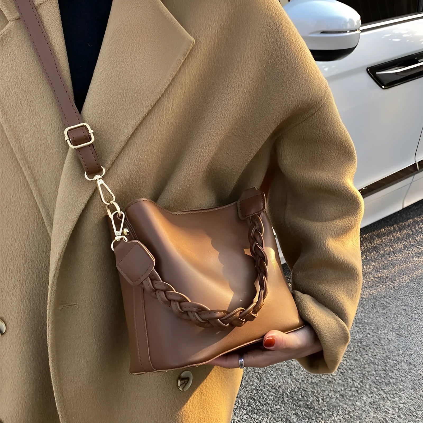 Khaki PU leather crossbody bucket bag with weaving texture and single shoulder strap.