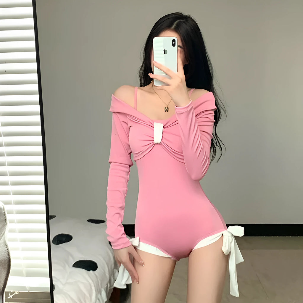 Women's long sleeve one-piece swimsuit in pink or black colours with figure-flattering design