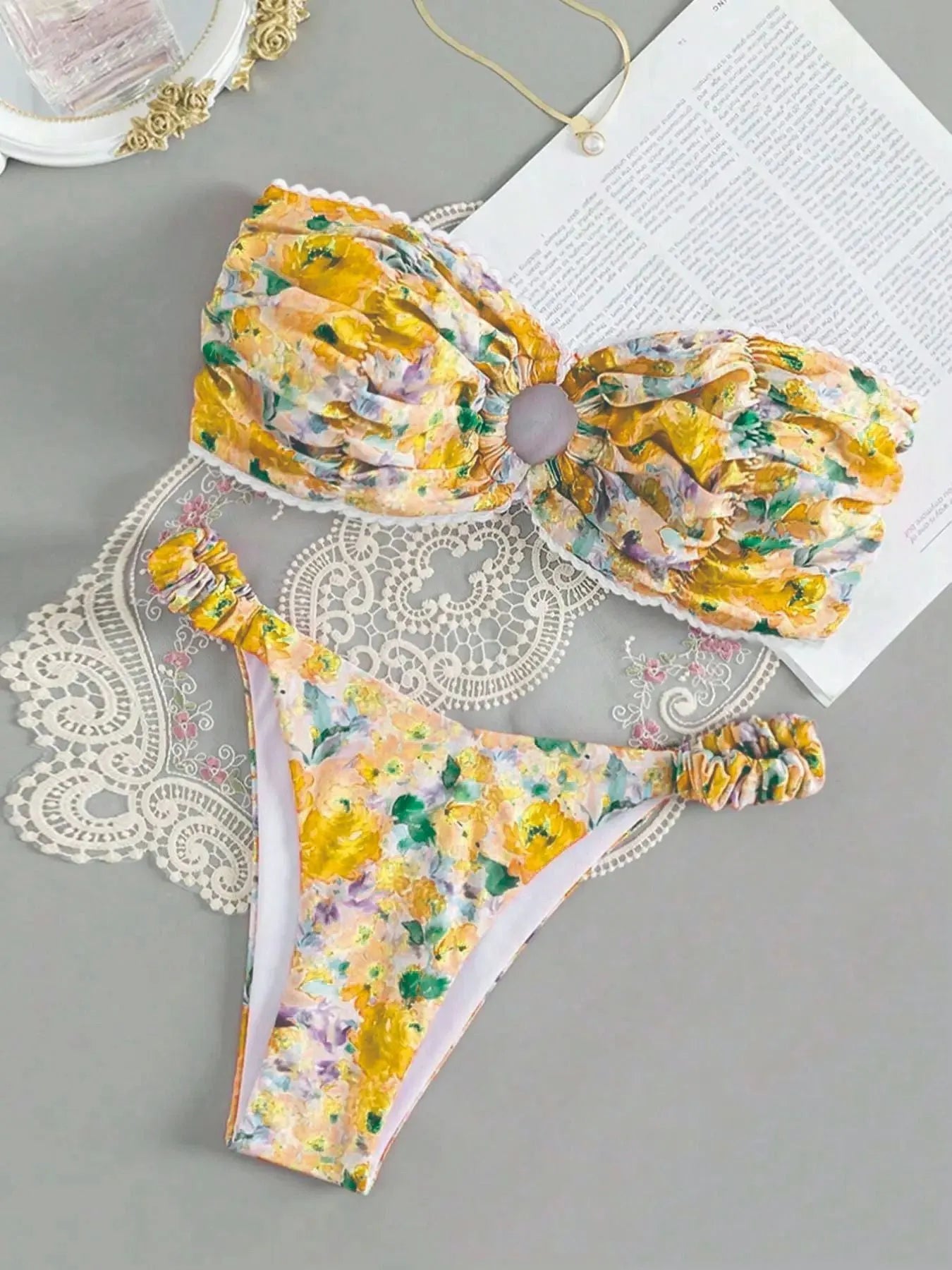 Blue floral print tube top bikini set with lace trim on a mannequin.