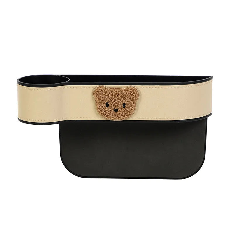 Leather car seat gap storage box with a cartoon bear design hanging between vehicle seats.