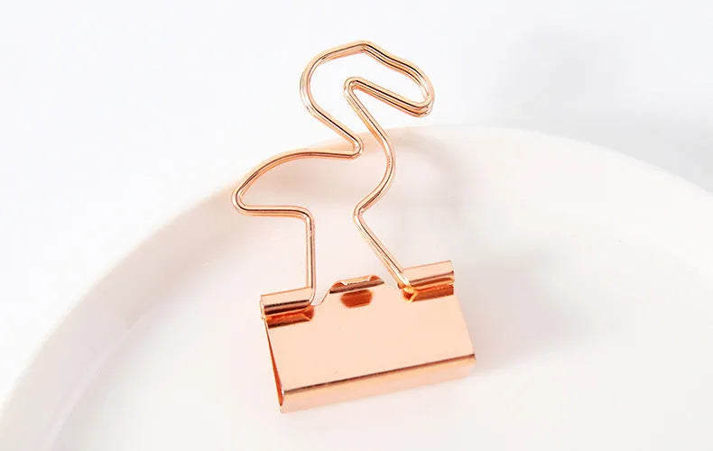 Gold long tail metal clip with decorative charm shape for document organisation