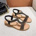 Women's patent leather beach sandals with rhinestone straps and non-slip soles in gold colour.
