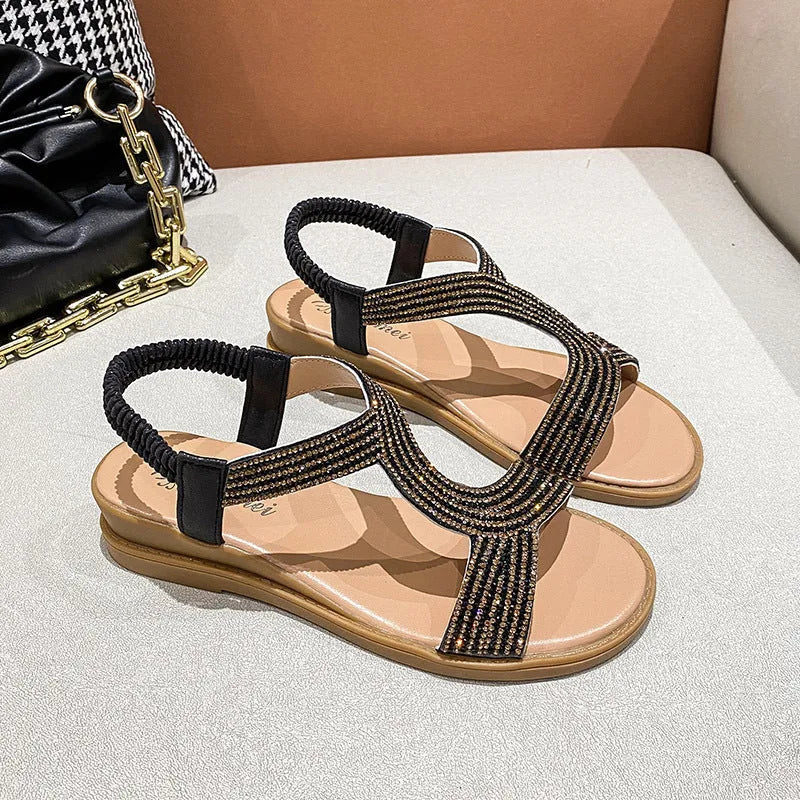 Women's patent leather beach sandals with rhinestone straps and non-slip soles in gold colour.