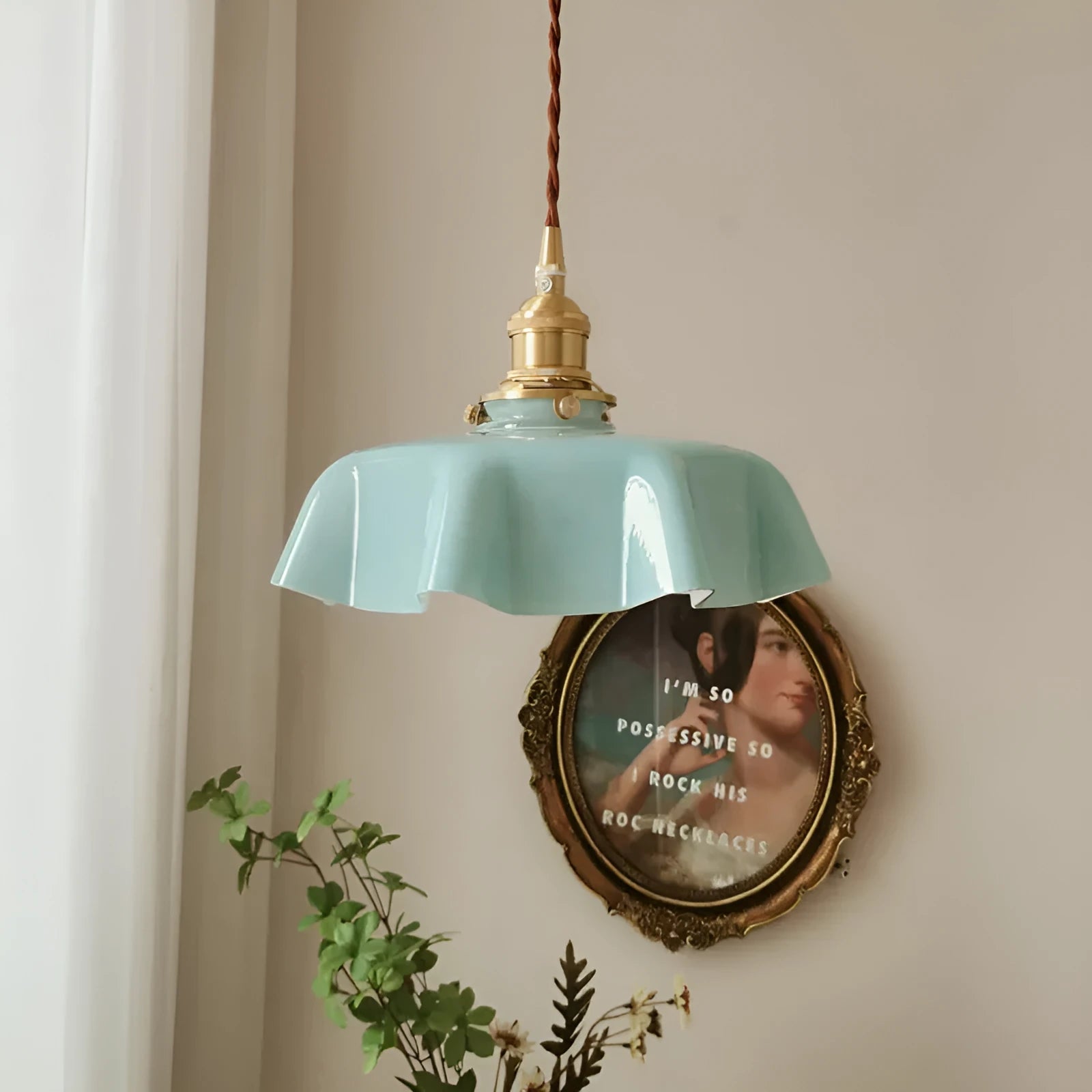 Medieval-style brass flower bud chandelier with a cream glass shade hanging from an adjustable cord.