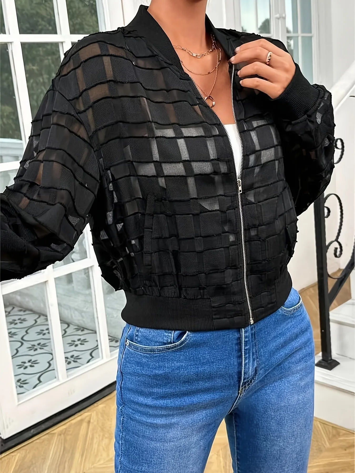 Black women's semi-transparent jacket with geometric pattern, zip-up front, and long sleeves