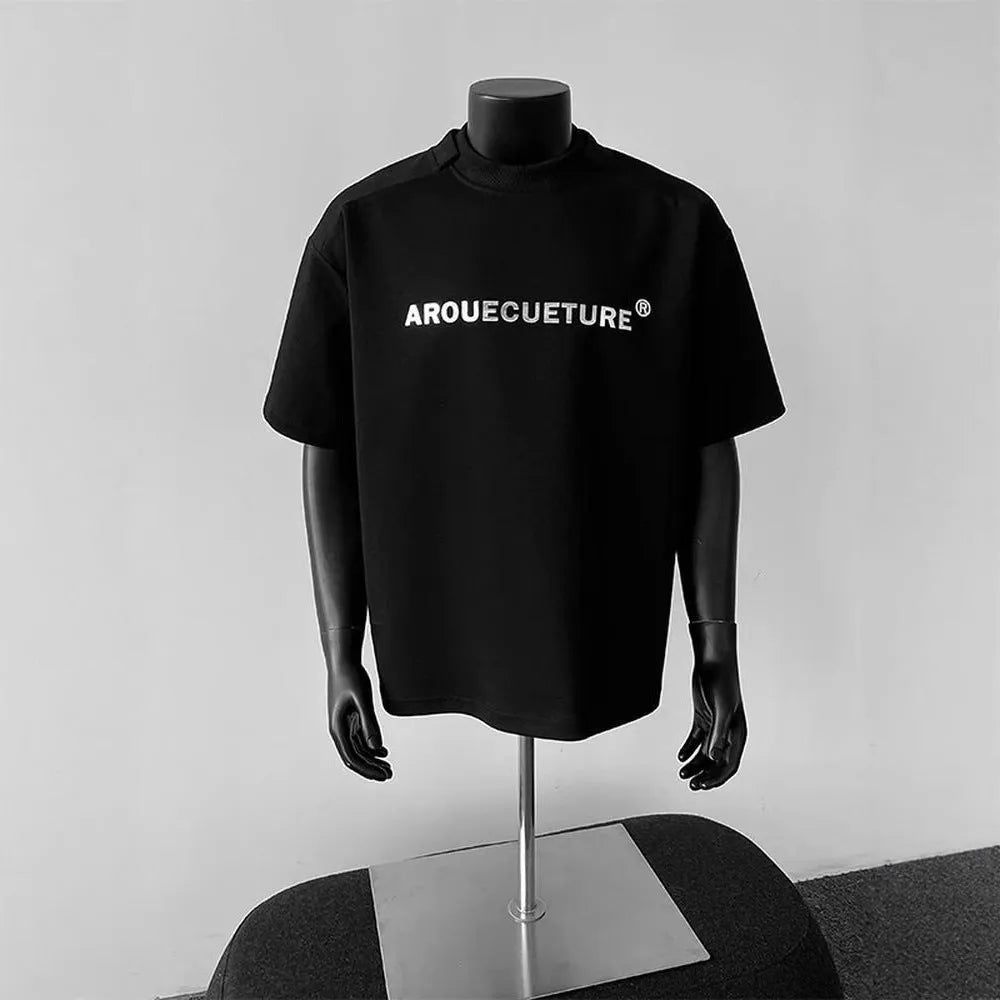 Men's plain black short sleeve cotton pullover shirt on a hanger, loose fit.