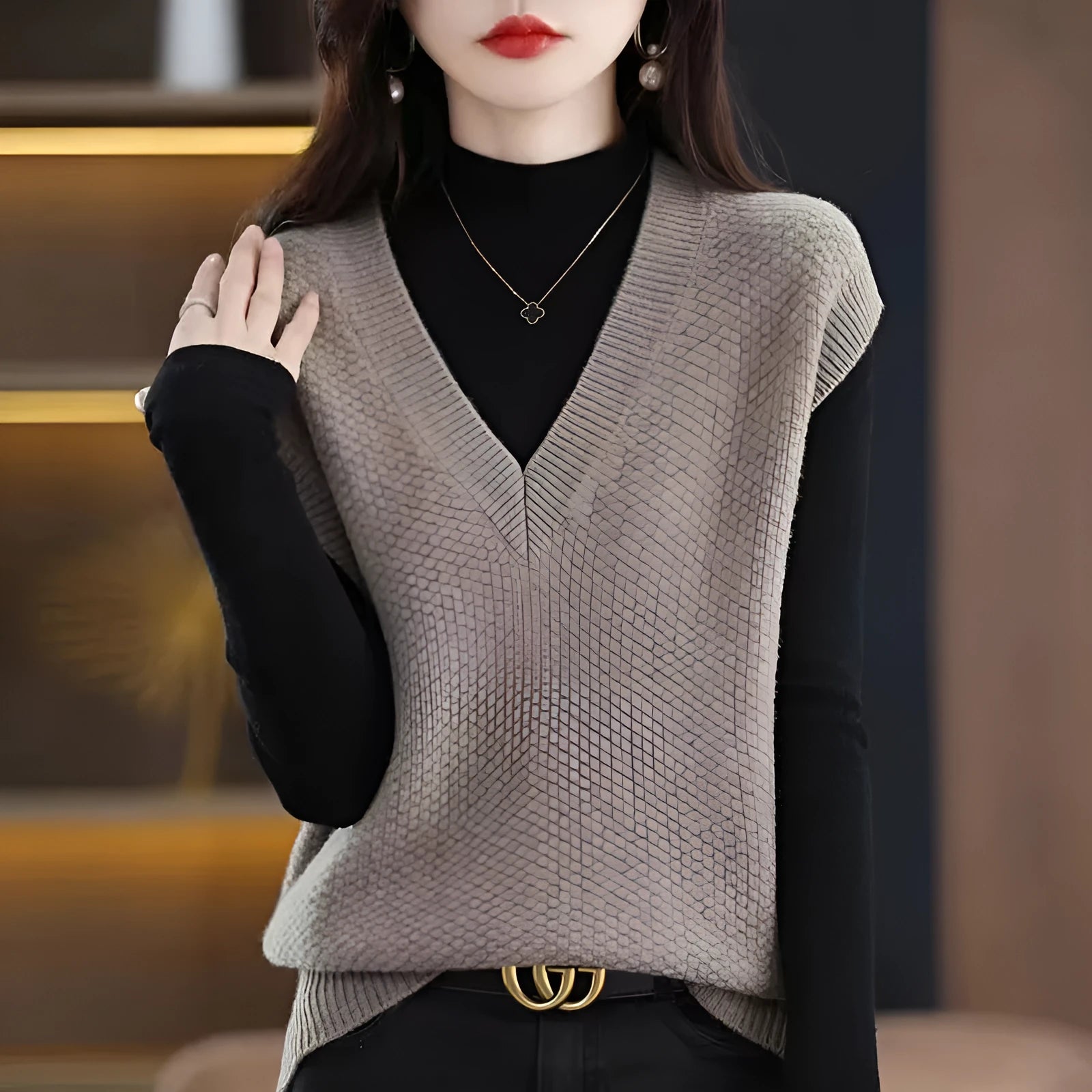 Creamy-white knitted sleeveless vest with 3D pattern and V-neck on a hanger