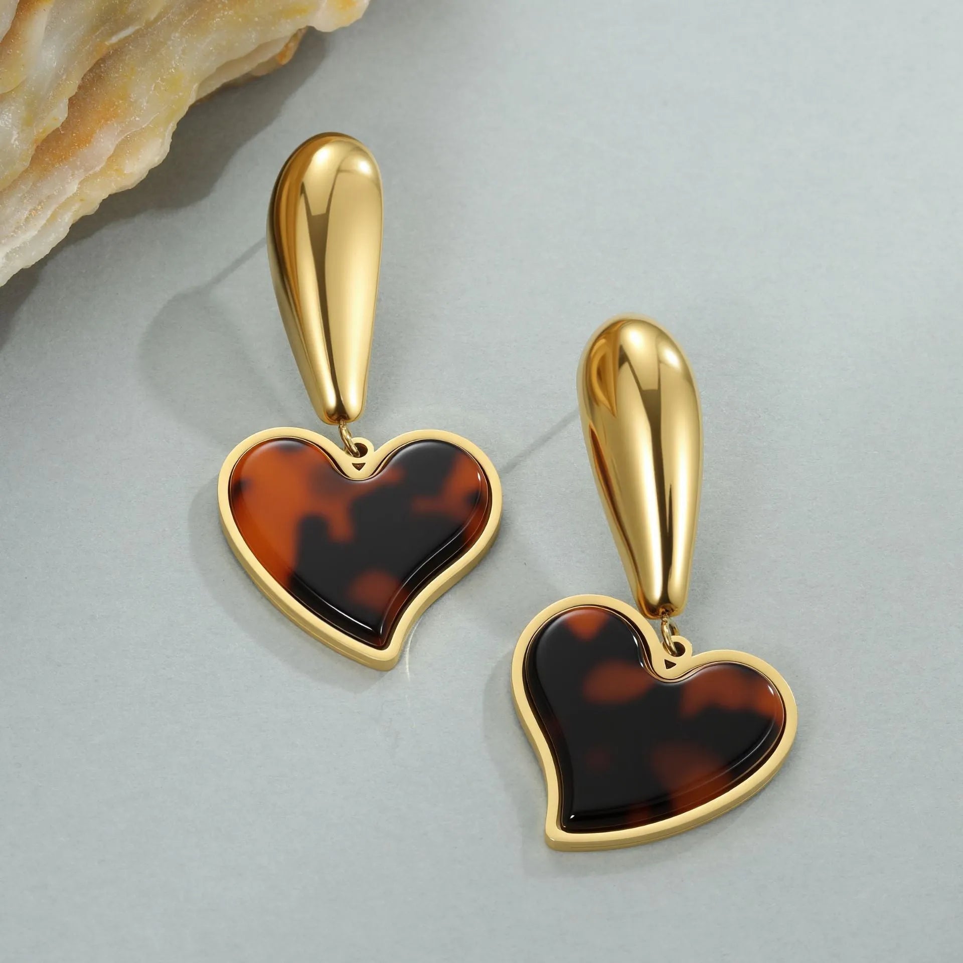 Gold electroplated tortoiseshell resin earrings in heart and geometric floral designs for women.