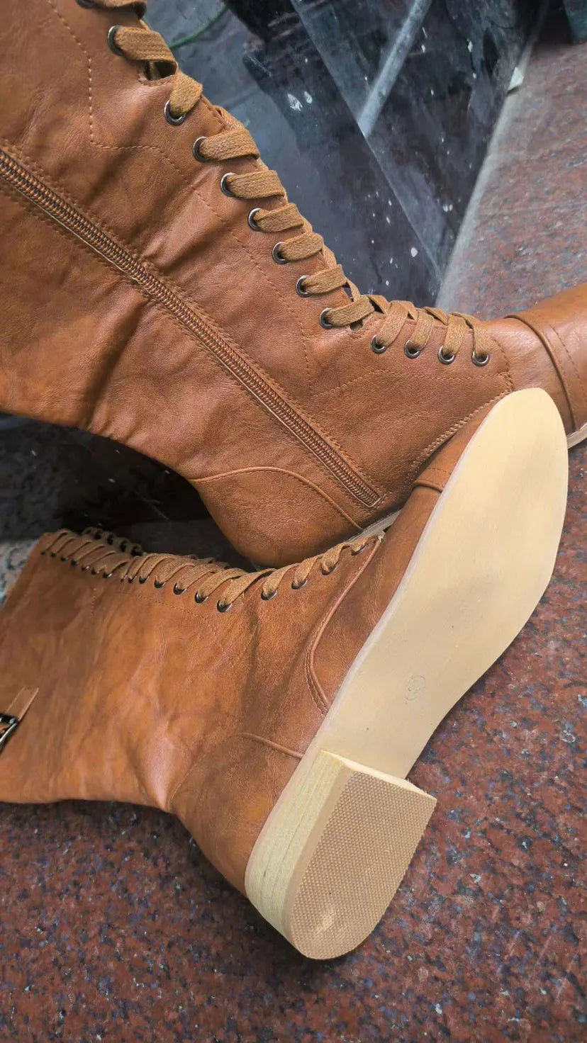 Women's black cross strap knight boots made from artificial PU.