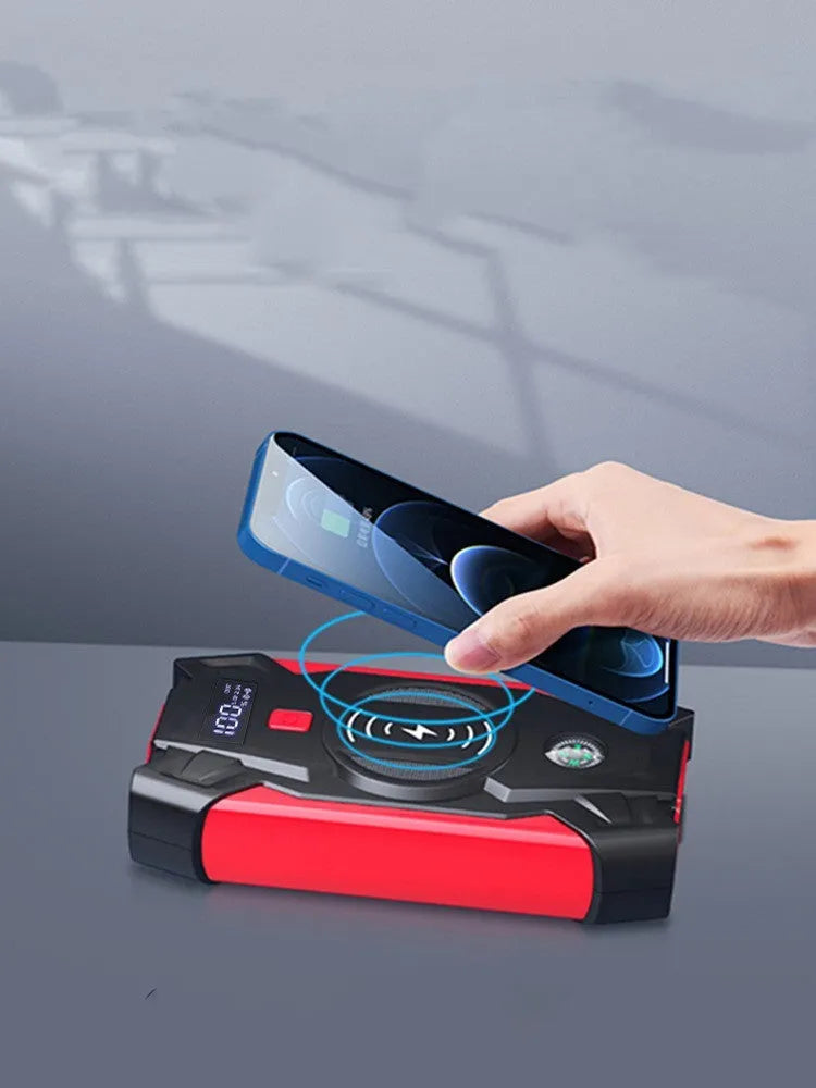 Red car emergency jump starter power pack showing digital display and battery clips