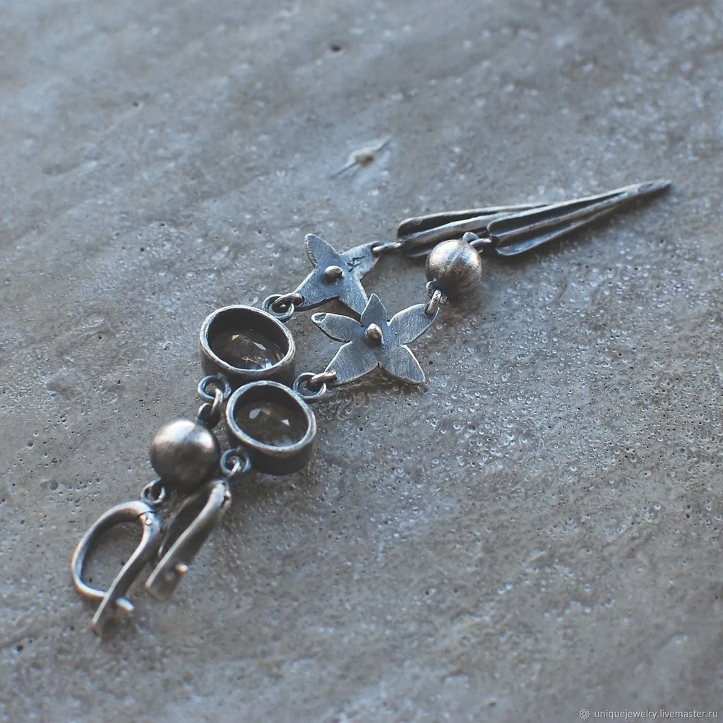 Hesheng geometric long pendant earrings with XINGX design and rhinestones in antique silver.