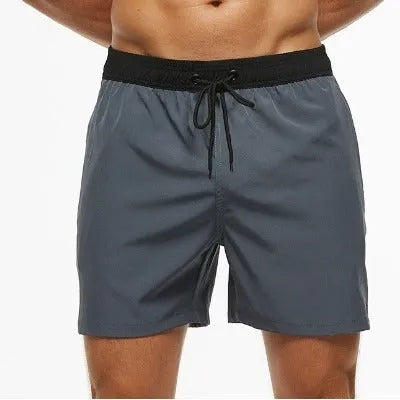 Men's blue drawstring shorts with a zippered pocket and stitching waist detail